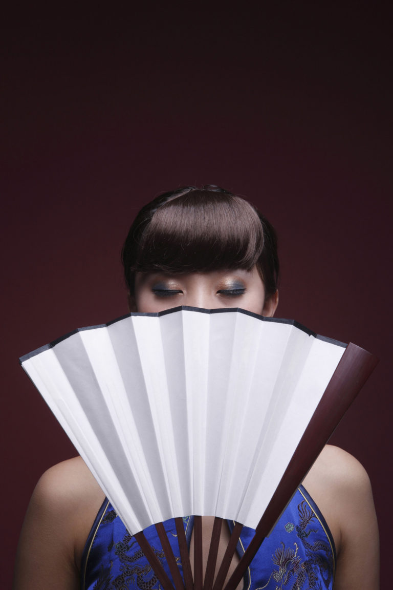 Woman In Cheongsam Covering Part Of Her Face With Fan, Eyes Closed