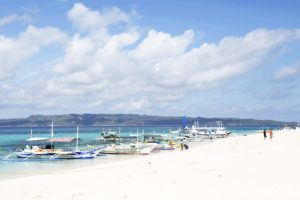 File Photo: Traditional Boats Line Up The Shore In A Secluded Beach On The Island Of Boracay, Central Philippines