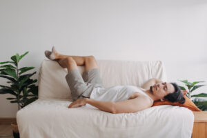 Weird and funny sleep pose of man in his apartment in boring day off.