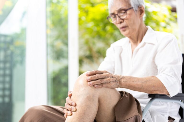 Close up,Leg of senior aged having pain in her knee,massage the