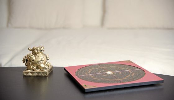 An Asian Symbol And A Feng Shui Compass On A Table