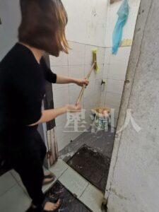 关丹利丽茶室的工人在打烊前清洗厕所，连墙壁也刷上强力清洁剂，确保达到效果。