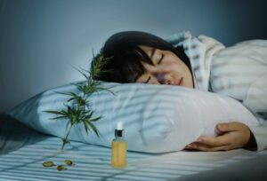 Asian Girl Sleeping In Evening Bedroom With Cbd Oil, Capsules And A Cannabis Branch. Melatonin Production, Concept Of Combat Sleep Disorders